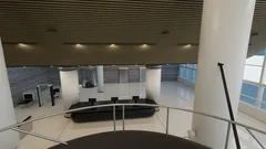 Thumbnail: The reception and security-screening area are seen beneath the ceiling slats, with the lift core beyond.