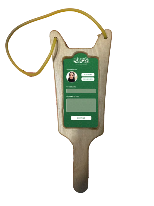 Wooden slingshot-shaped controller with a green photo and message interface.