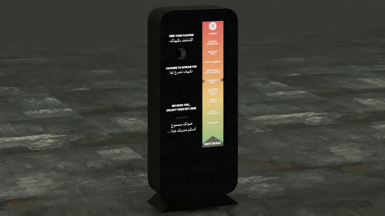 Black freestanding sound-activation booth with a microphone opening, gift slot and tall green-to-red heat scale.