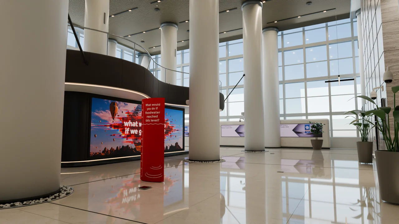 The ground-level view brings the column grid, glazed perimeter, curved media wall and reflective floor into one composition.