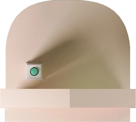 A pale arched booth surface with a single green push button.